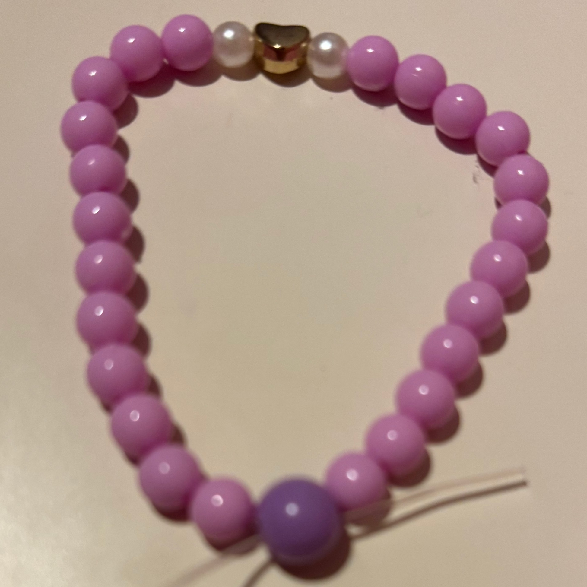 Purple beaded bracelet on a light surface
